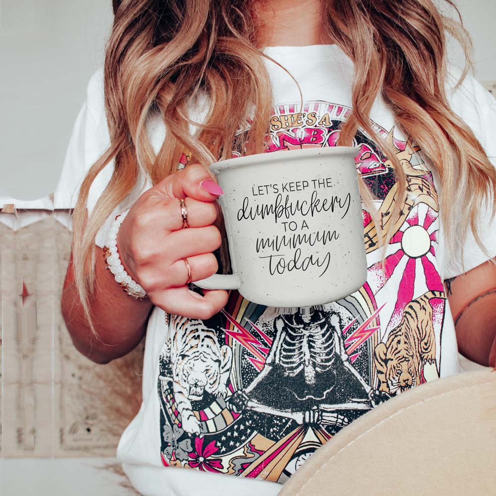 White speckled coffee mug with black typography humor
